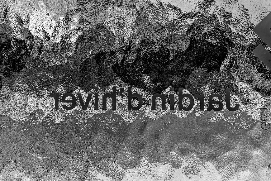 Black and white abstract texture of frosted glass with reversed text