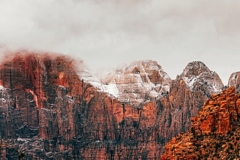Dramatic Red Rock Mountains with Snow and Fog