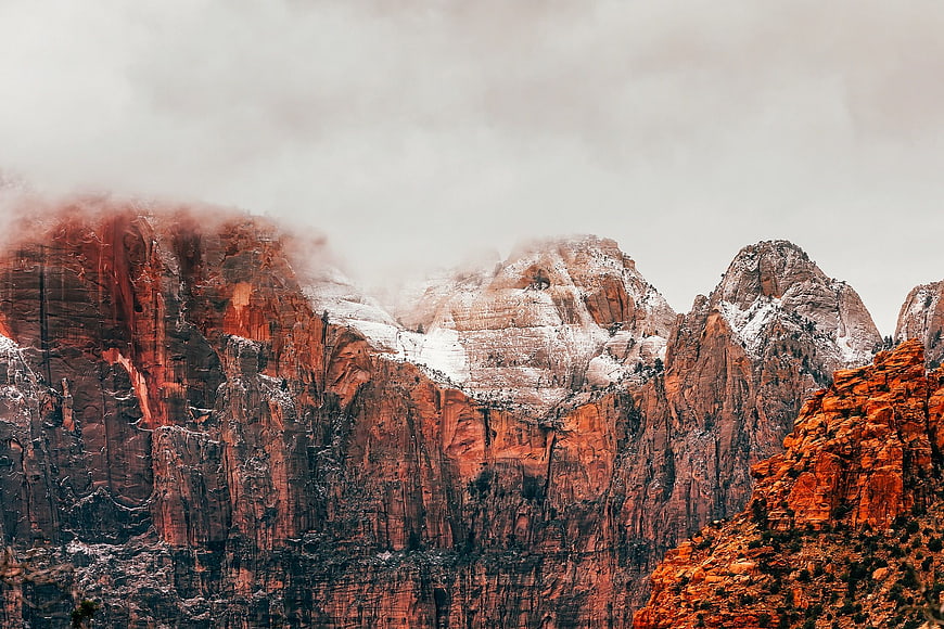 Dramatic Red Rock Mountains with Snow and Fog