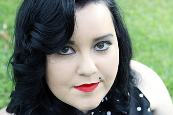 Close-up portrait of woman with retro makeup and red lips