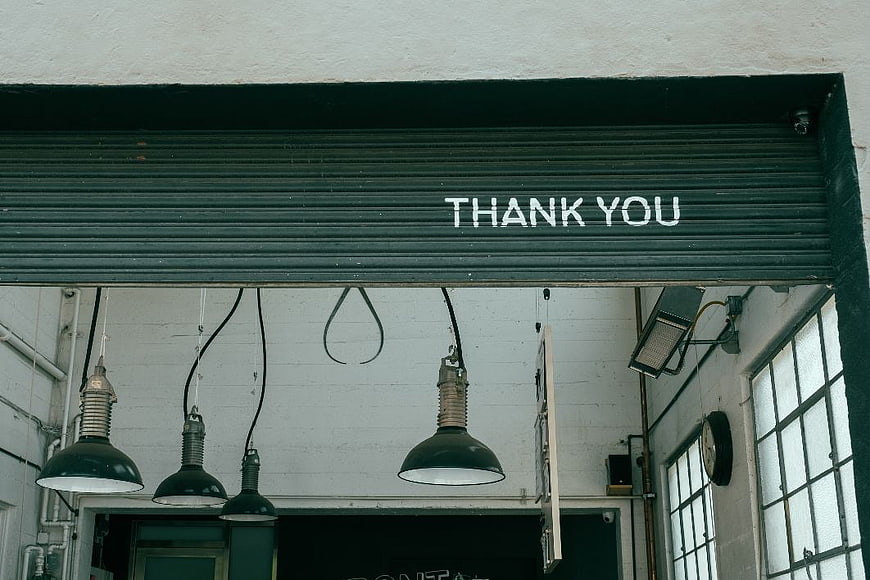 Thank You Sign on Green Roller Shutter in Industrial Loft