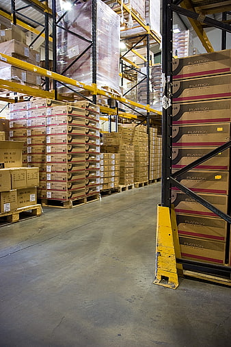 Warehouse aisle with stacked boxes and industrial racking