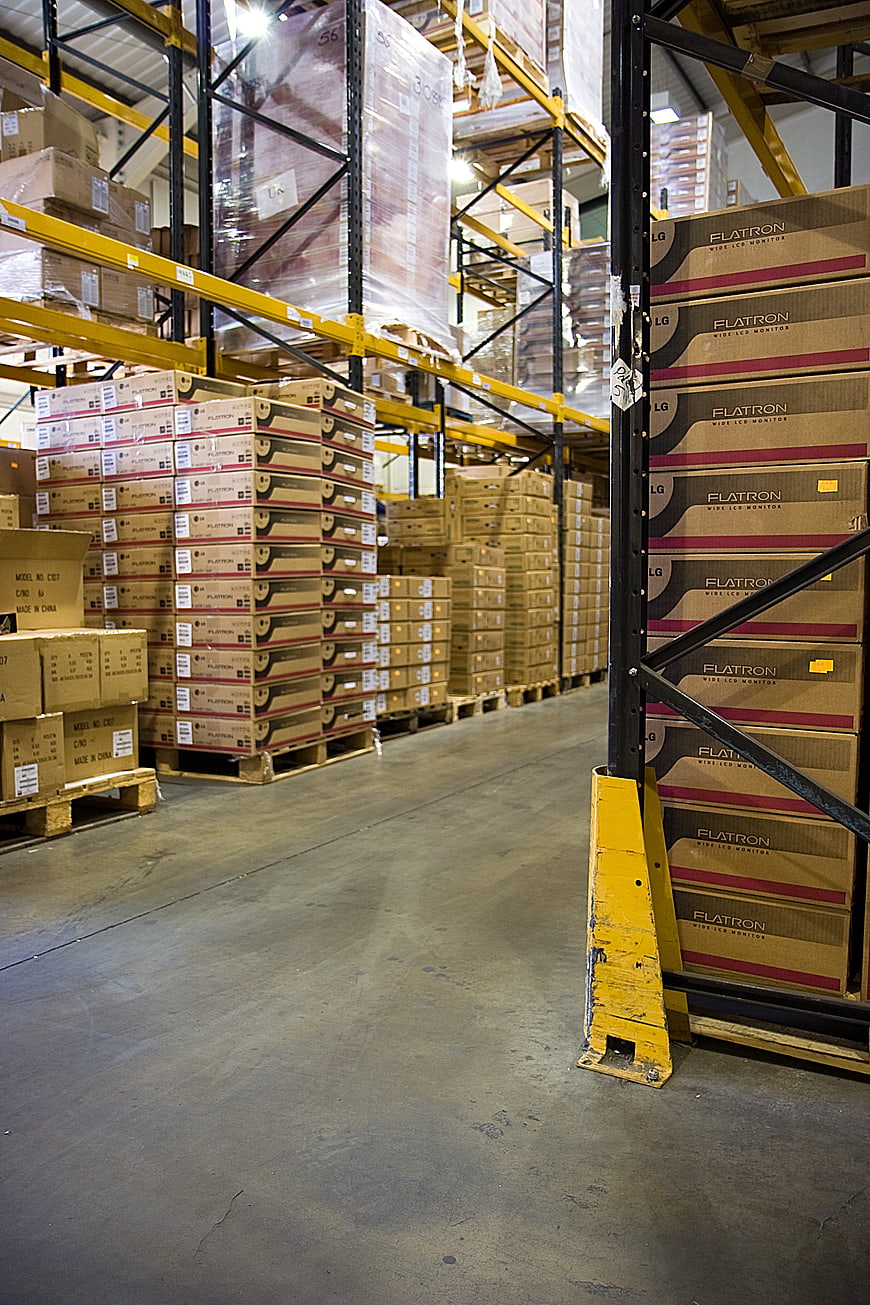 Warehouse aisle with stacked boxes and industrial racking