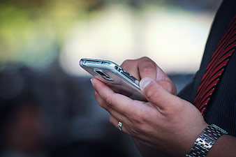 Close-up of businessman using smartphone outdoors