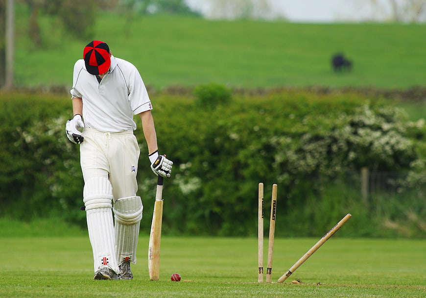 Dejected Cricketer Walking Off After Being Bowled Out