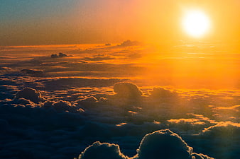 Golden sunset above sea of clouds aerial view