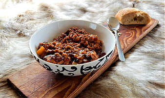 Rustic Bowl of Chili Con Carne with Bread on Wooden Board