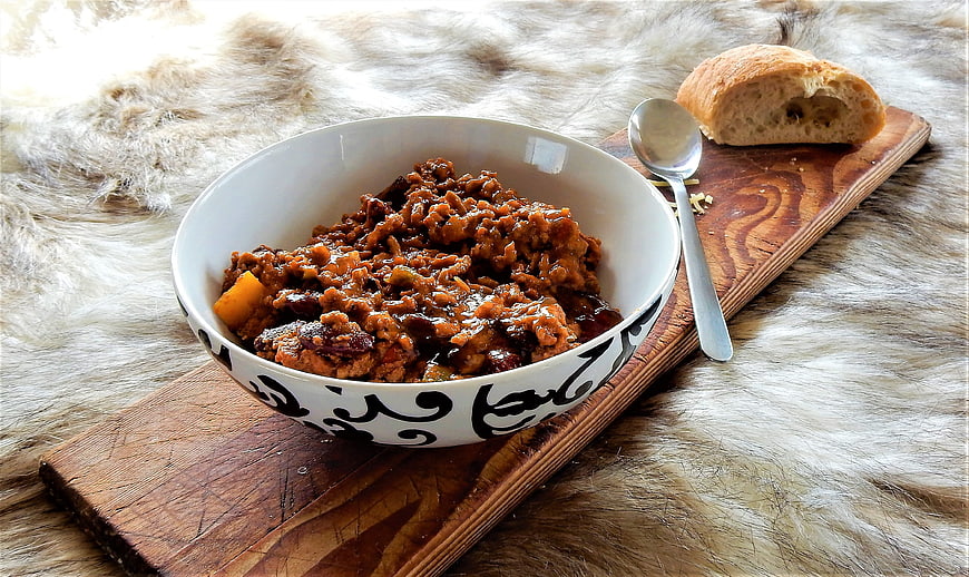Rustic Bowl of Chili Con Carne with Bread on Wooden Board