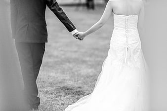 Bride and Groom Holding Hands Walking Away in Black and White