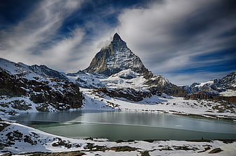 Matterhorn Mountain Peak with Alpine Lake and Snowy Landscape