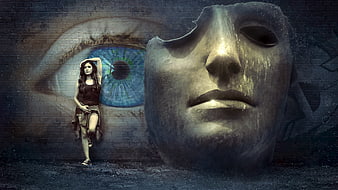 Surreal woman posing with giant mask and eye graffiti