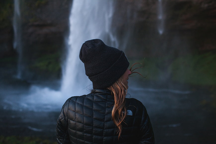 Woman in Black Beanie Watching Waterfall