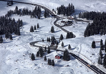 Aerial View of Winding Mountain Road in Snowy Winter Landscape