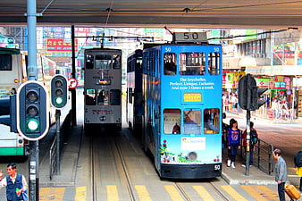 Blue Hong Kong Tram On Busy Urban Street With Pedestrians