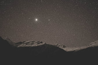 Snowy Mountain Peaks Under Starry Night Sky