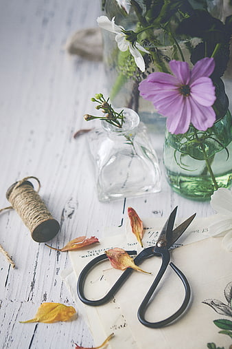 Rustic floral arrangement with vintage scissors and dried leaves