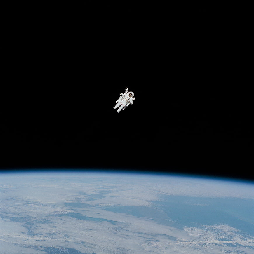 Astronaut Floating in Space Above Earth Atmosphere