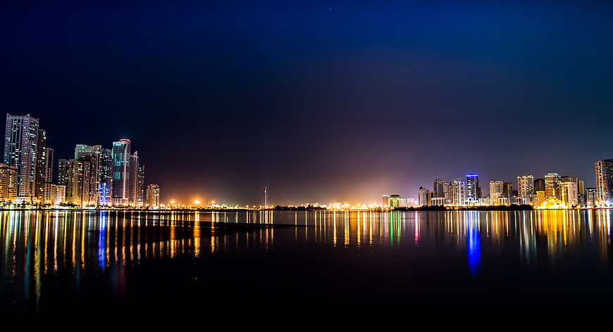 Night Skyline of Modern City with Water Reflections