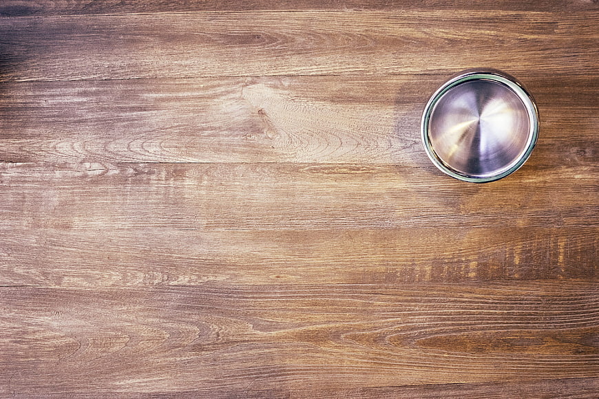 Stainless Steel Bowl On Rustic Wooden Table Background