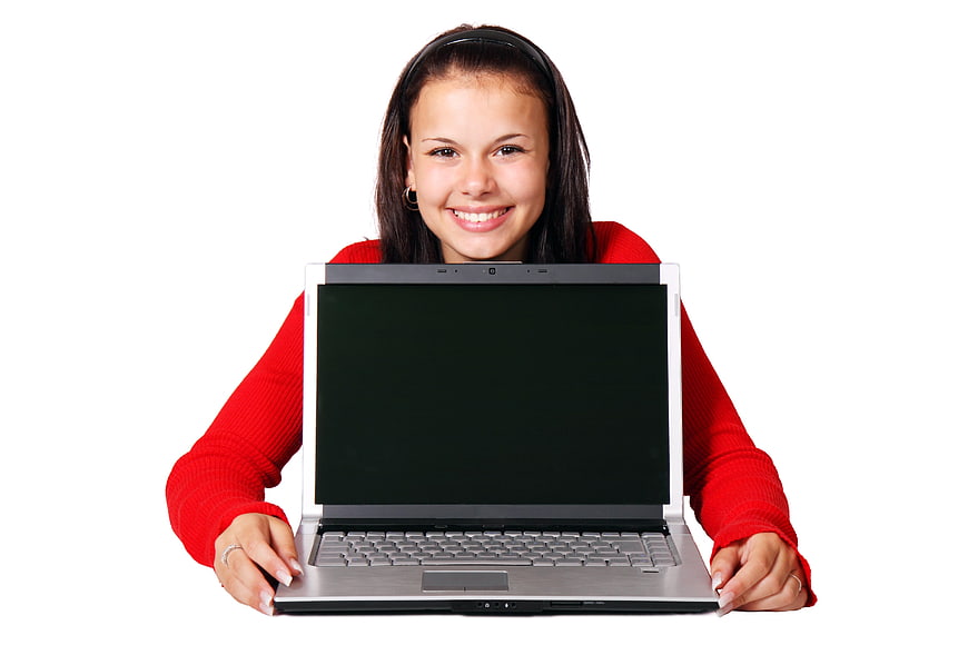 Smiling young woman holding laptop with blank screen