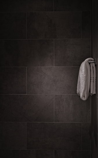 Dark Gray Tiled Bathroom Wall with White Towel