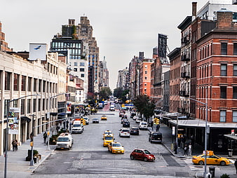 Wide Manhattan Street with Yellow Taxis and Brick Buildings