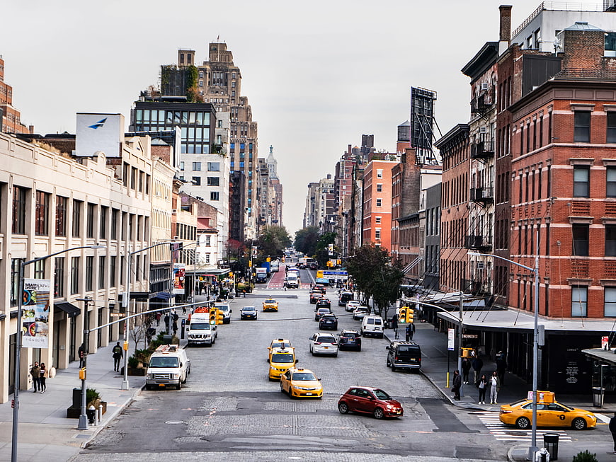 Wide Manhattan Street with Yellow Taxis and Brick Buildings
