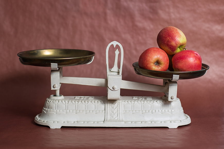 Vintage Scale with Red Apples on Pink Background