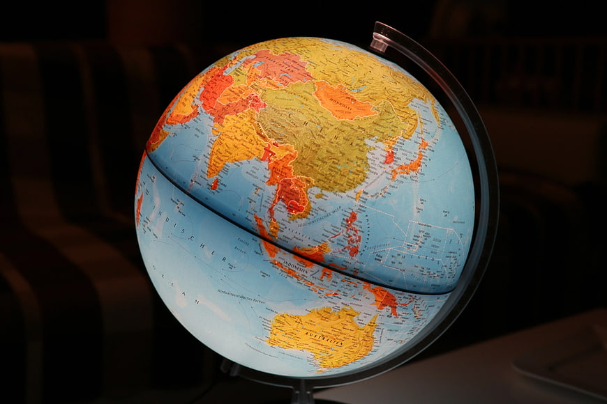 Illuminated Globe Showing Asia and Australia on Dark Background