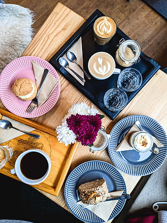 Top view of coffee and desserts on wooden trays