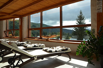 Luxury Spa Lounge Interior With Mountain View And Wicker Loungers