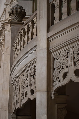 Detailed Stone Balcony with Floral Carvings and Balusters