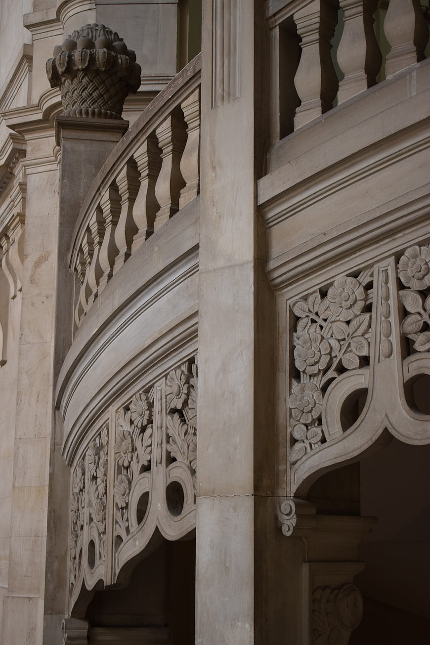 Detailed Stone Balcony with Floral Carvings and Balusters