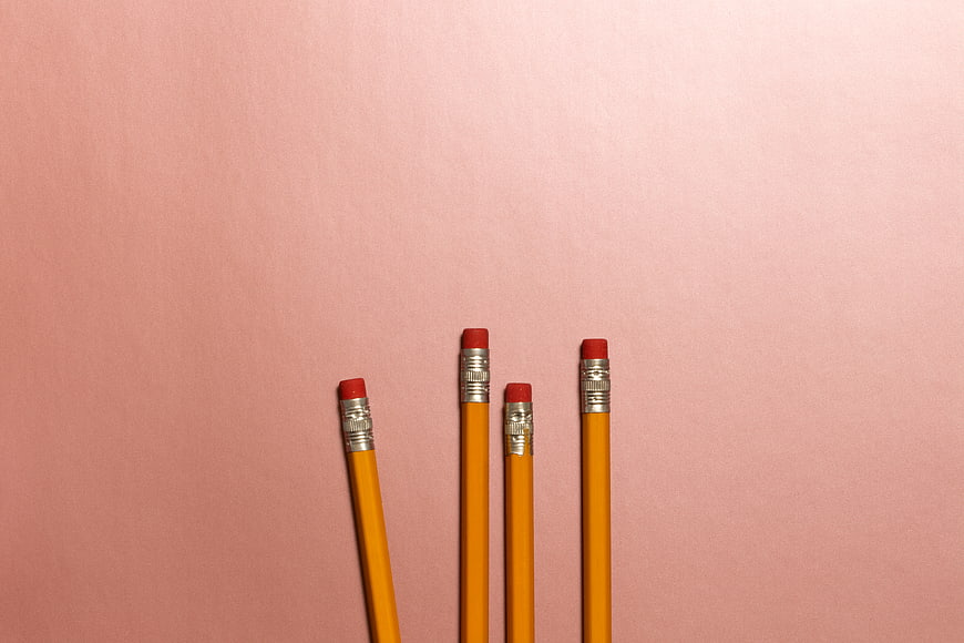 Yellow pencils on pink background with copyspace