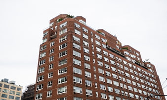 Low Angle View of Red Brick High-Rise Apartment Building