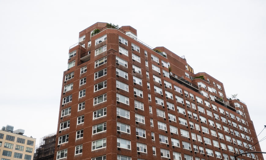 Low Angle View of Red Brick High-Rise Apartment Building