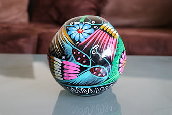 Hand-painted Mexican folk art sphere with vibrant floral and bird motifs