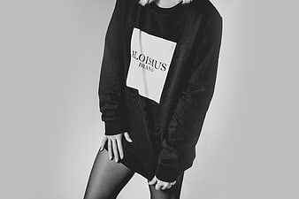 Woman in Oversized Black Sweatshirt with White Logo