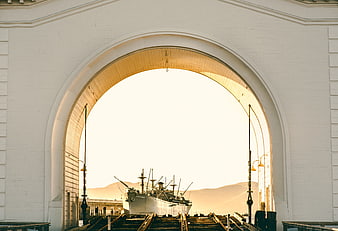 White Archway Framing Historic Ship at Dry Dock
