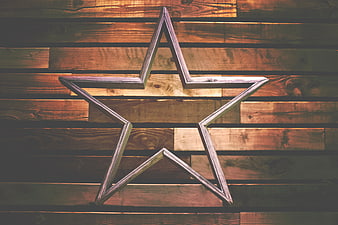 Rustic wooden star decoration on plank background
