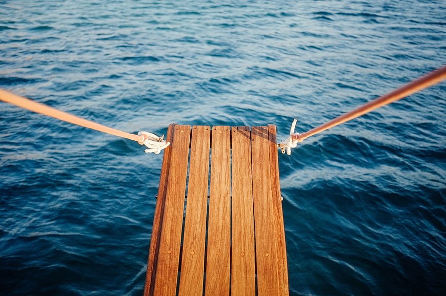 Wooden Gangway Planks Over Blue Ocean Water