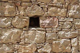Ancient stone wall texture with small opening