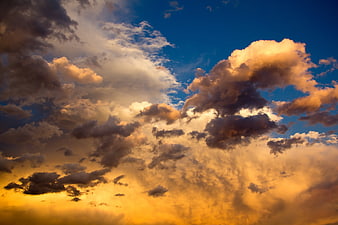 Dramatic sunset sky with golden clouds and blue patches