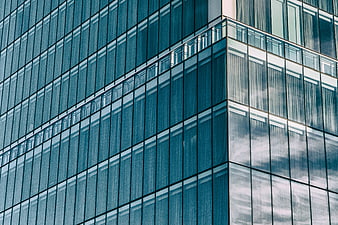 Modern Glass Office Building Facade with Cloud Reflections