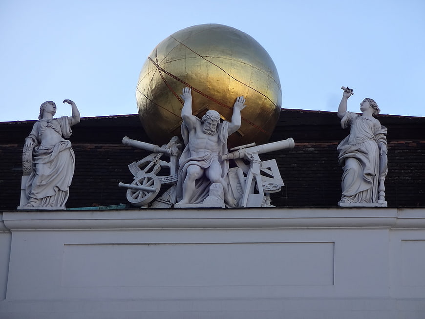 Atlas Sculpture Holding Golden Globe on Building Roof