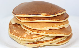 Stack of Golden Brown Pancakes on White Plate