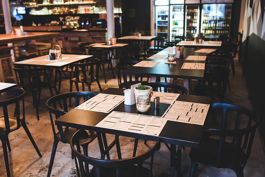 Empty modern restaurant interior with tables and menus