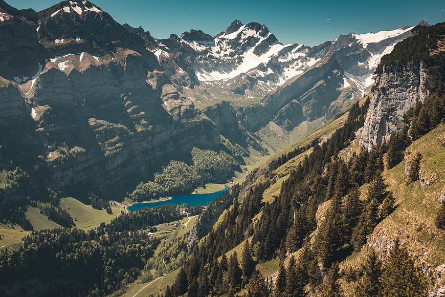 Majestic Alpine Landscape with Snowy Peaks and Turquoise Lake