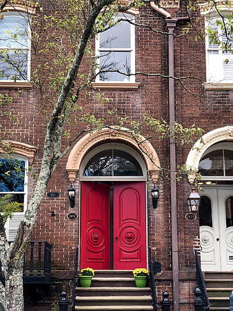 Red Double Door on Classic Brick Building Facade