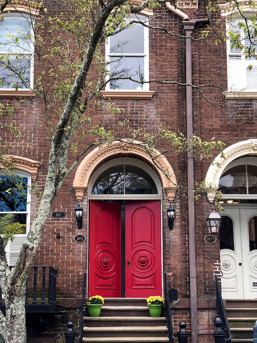 Red Double Door on Classic Brick Building Facade